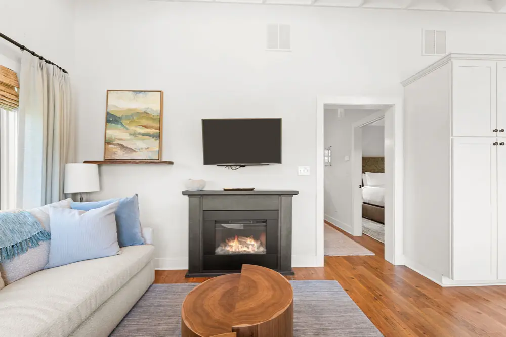 Living room with fireplace, TV, and comfortable sofa. 