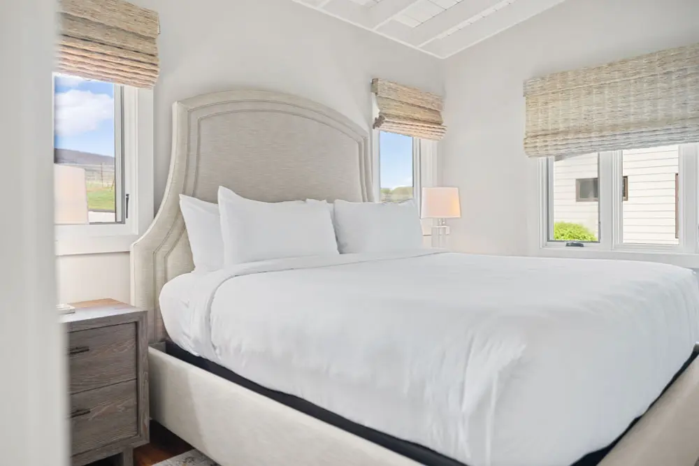 Bed with beige headboard.