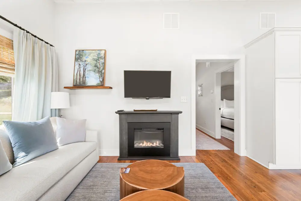 Living room with fireplace, TV, and comfortable sofa.