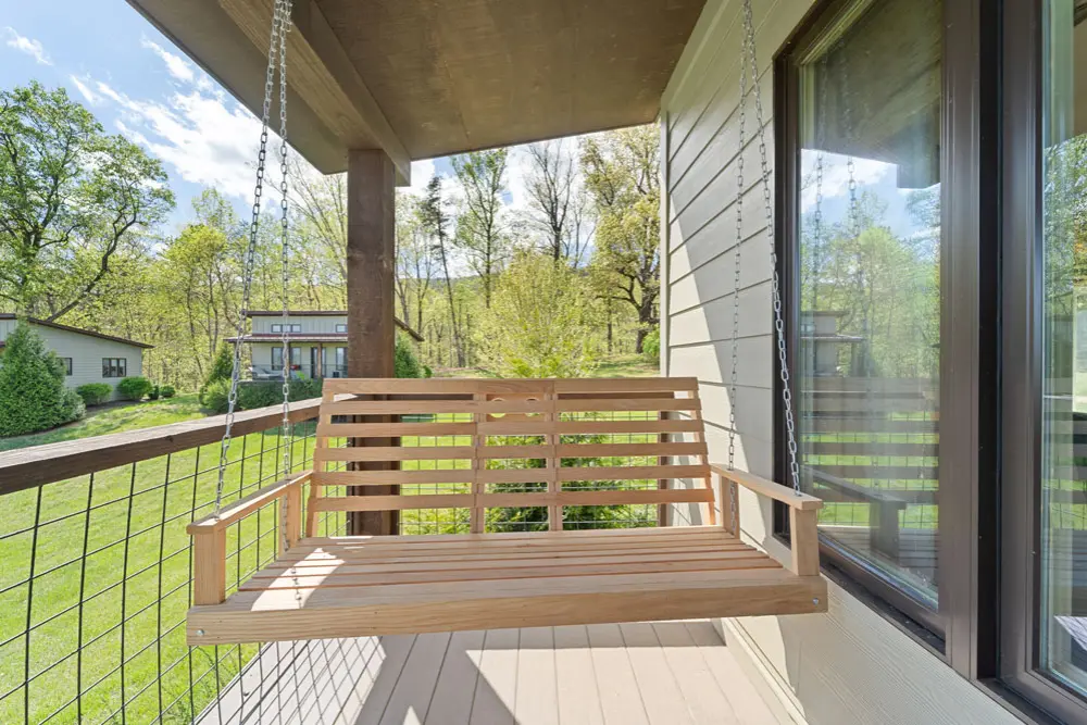 Wooden porch swing overlooking a mountain view