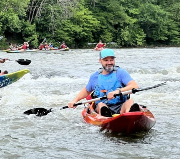 Man Kayaking in a river.