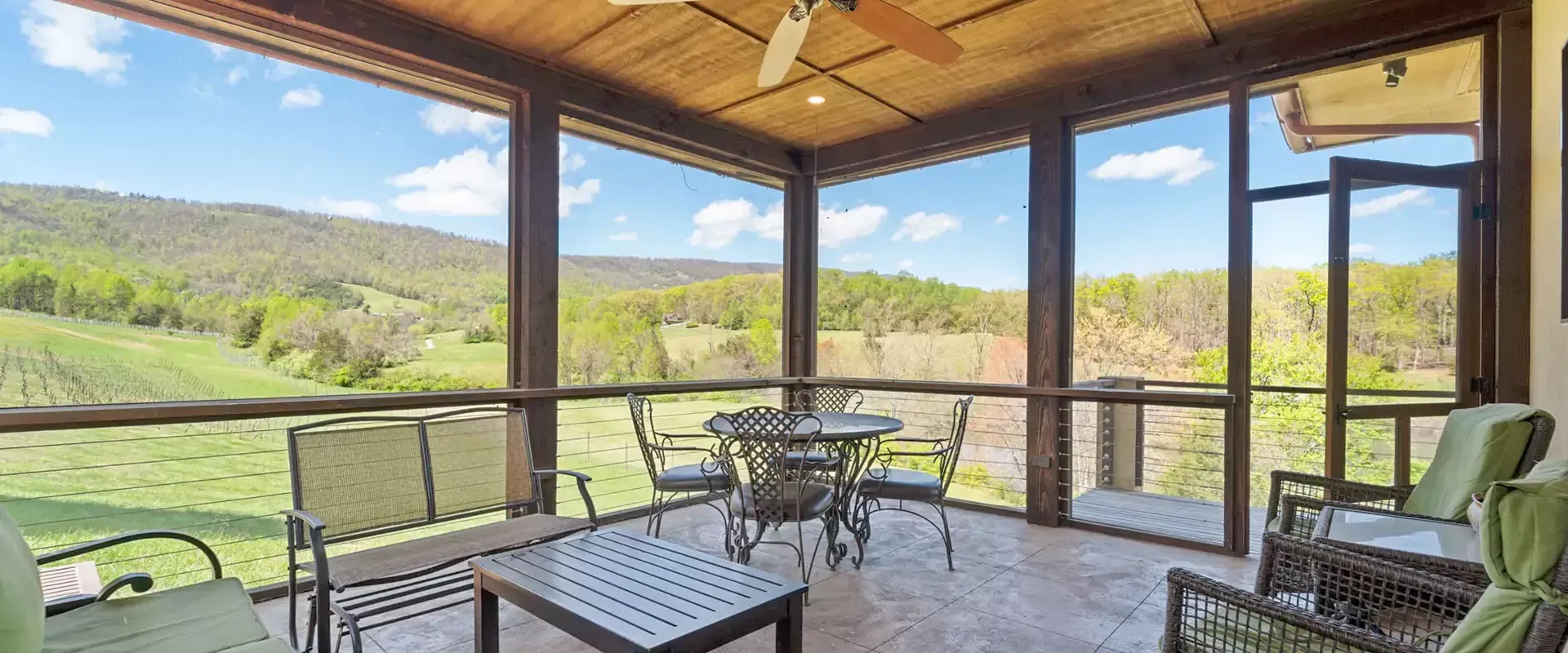 Surrounded by chairs, offering scenic mountain views outside.