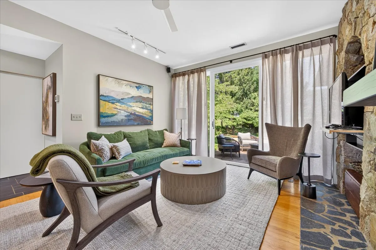Comfortable living room with fireplace and patio access.