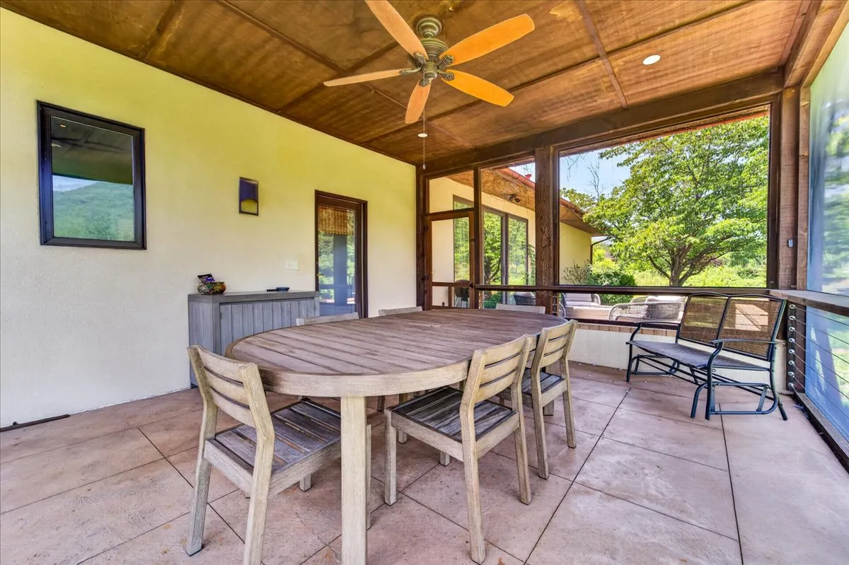 Covered outdoor dining patio with countryside views.