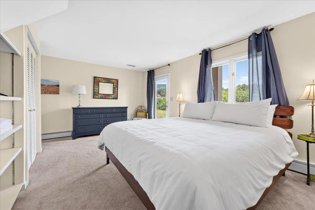 Guest bedroom with king bed and scenic countryside views.