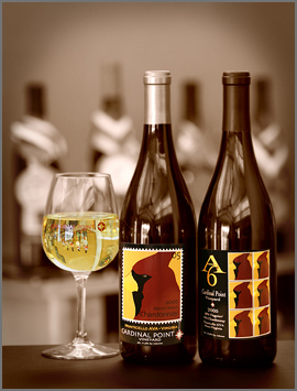 Two bottle of wine and a glass.